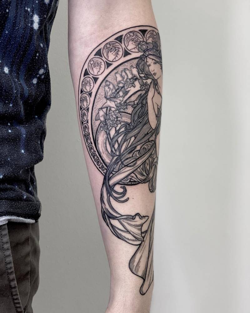 Engraving style woman tattoo done on the forearm.