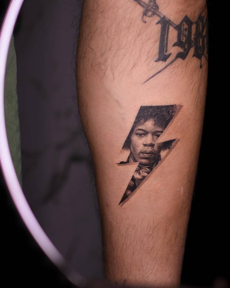 Lightning bolt Jimi Hendrix tattoo located on the calf.