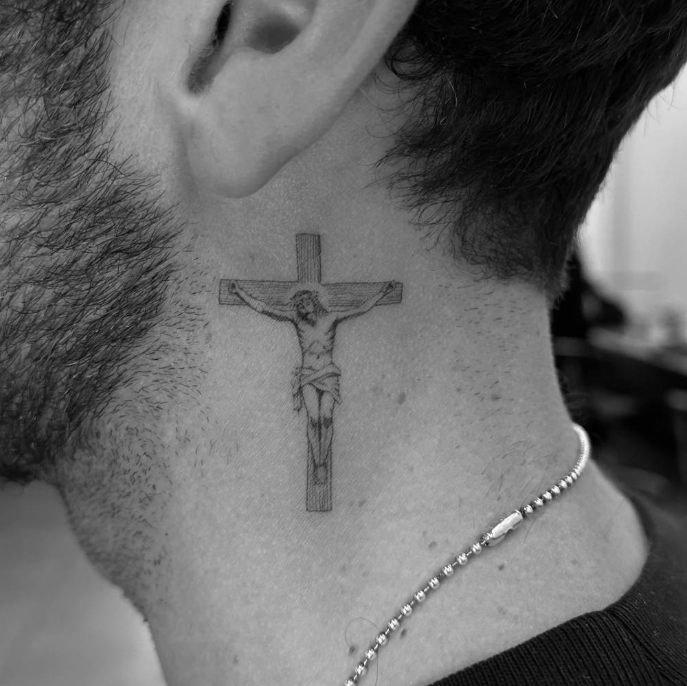 Crucifix tattoo located on the neck, illustrative style.