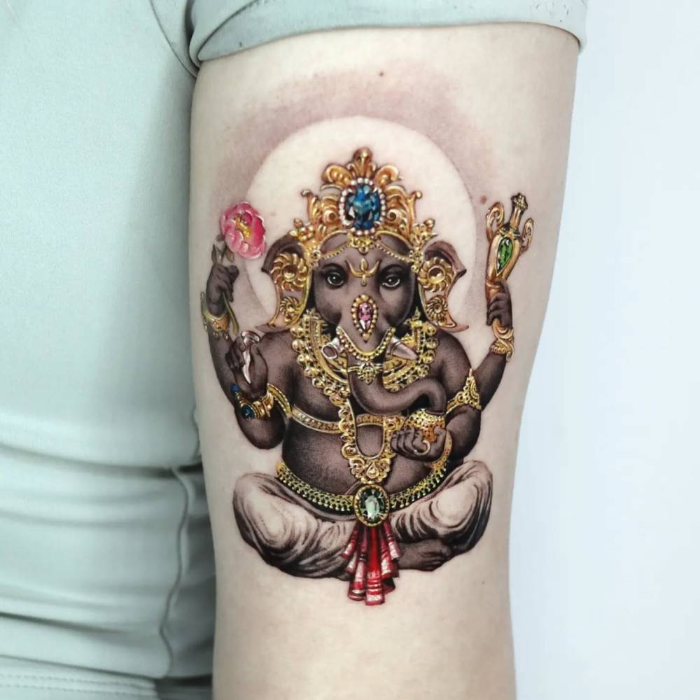 Ganesha tattoo located on the tricep.