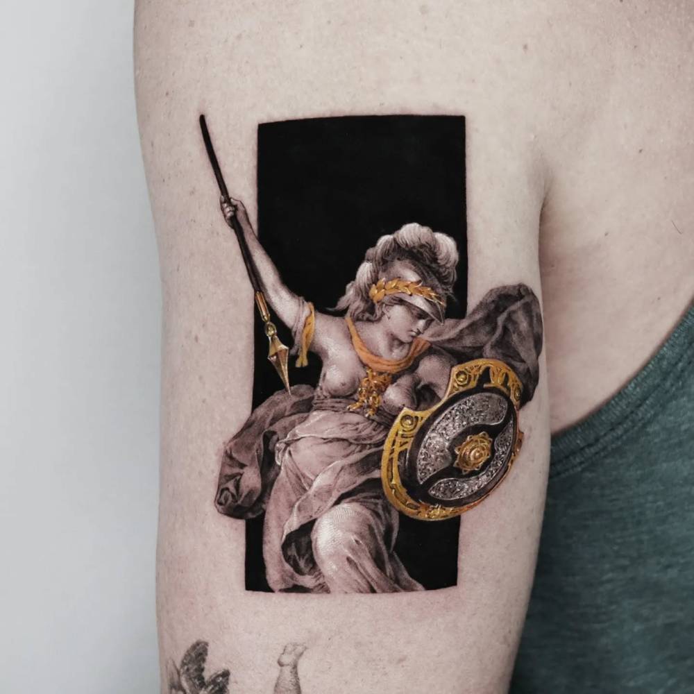 Micro-realistic style Athena tattoo placed on the tricep.