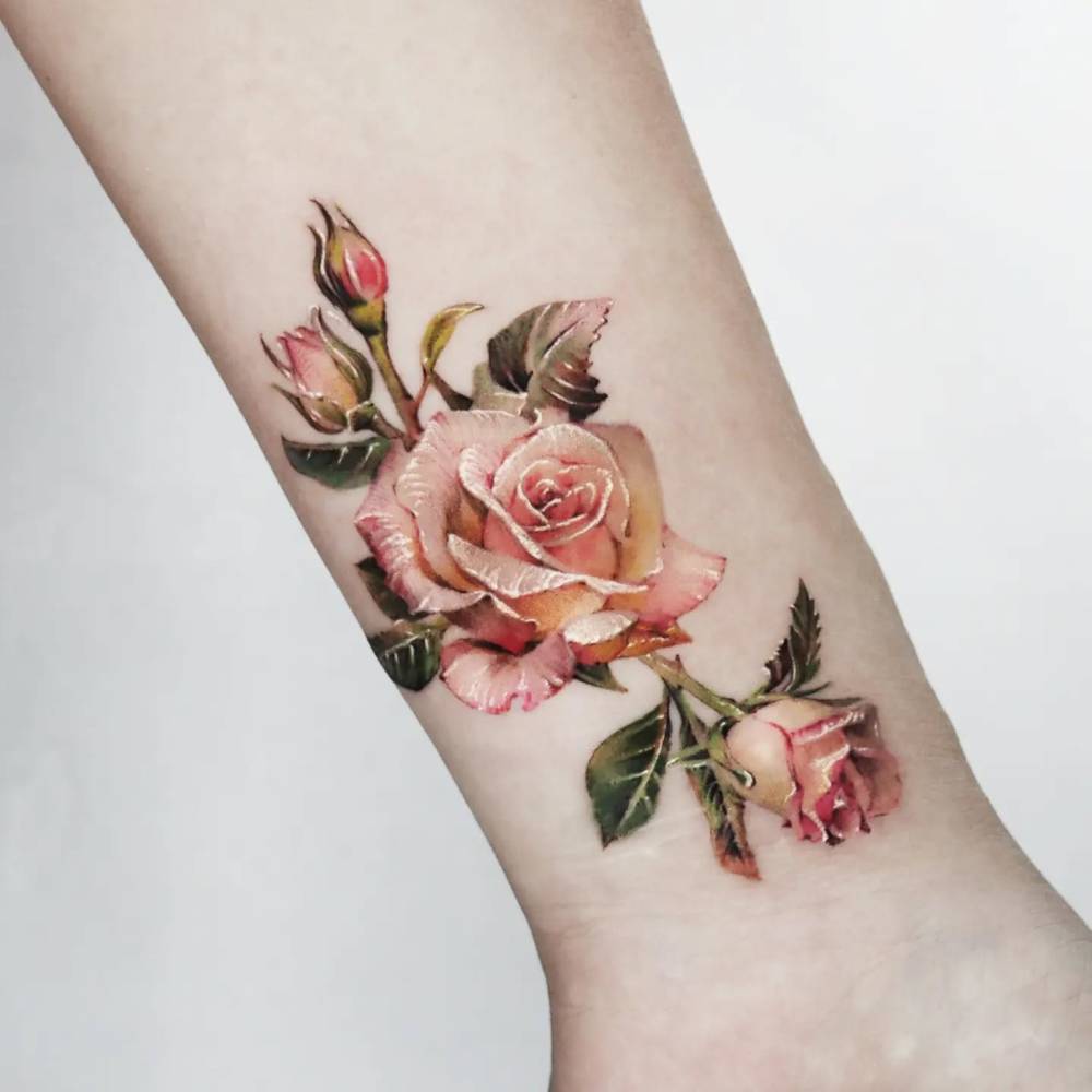 Pink roses tattooed on the wrist, realistic style.
