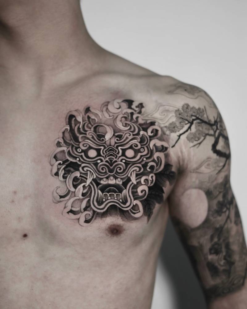 Foo dog tattoo in oriental style located on the chest.