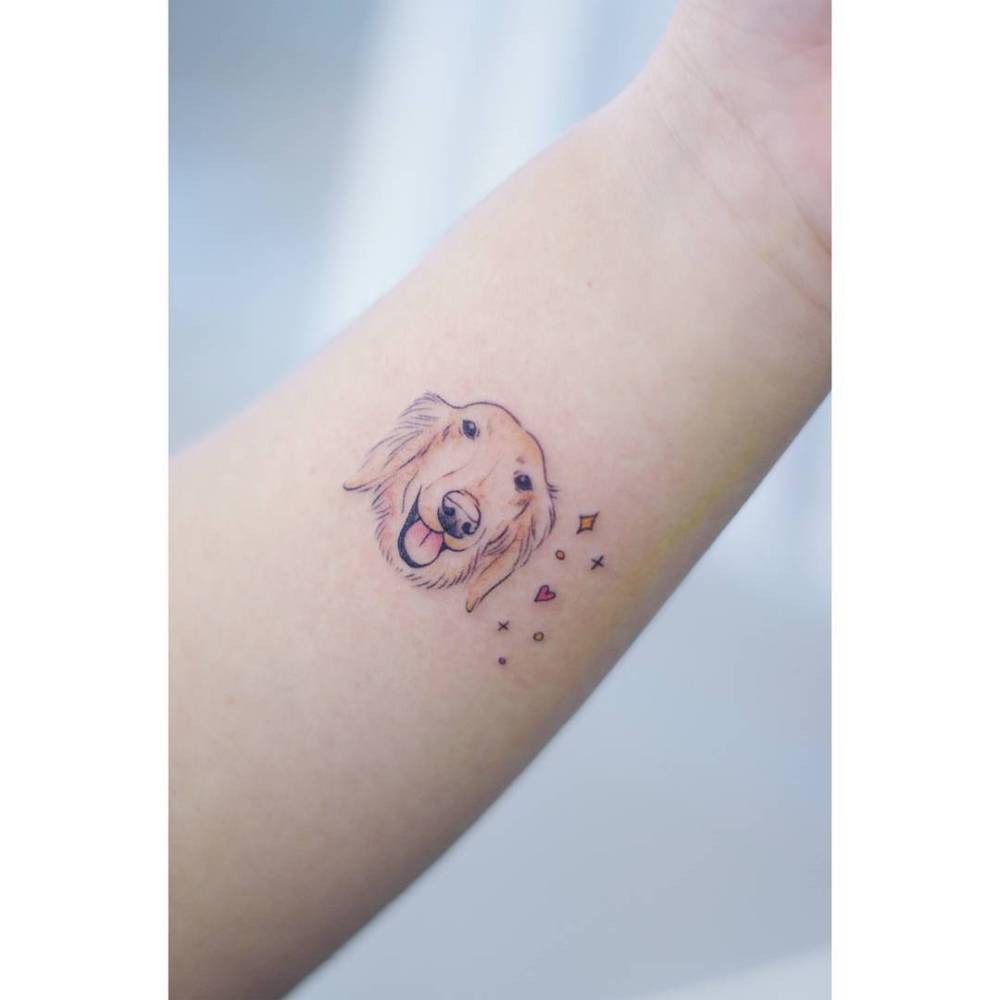 Golden Retriever portrait tattoo located on the wrist.