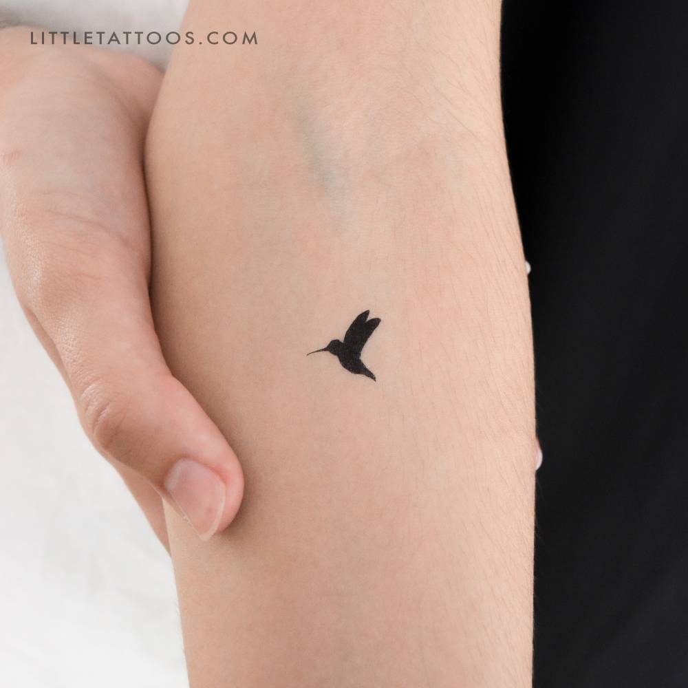 Blackwork style little hummingbird temporary tattoo located on the inner forearm.