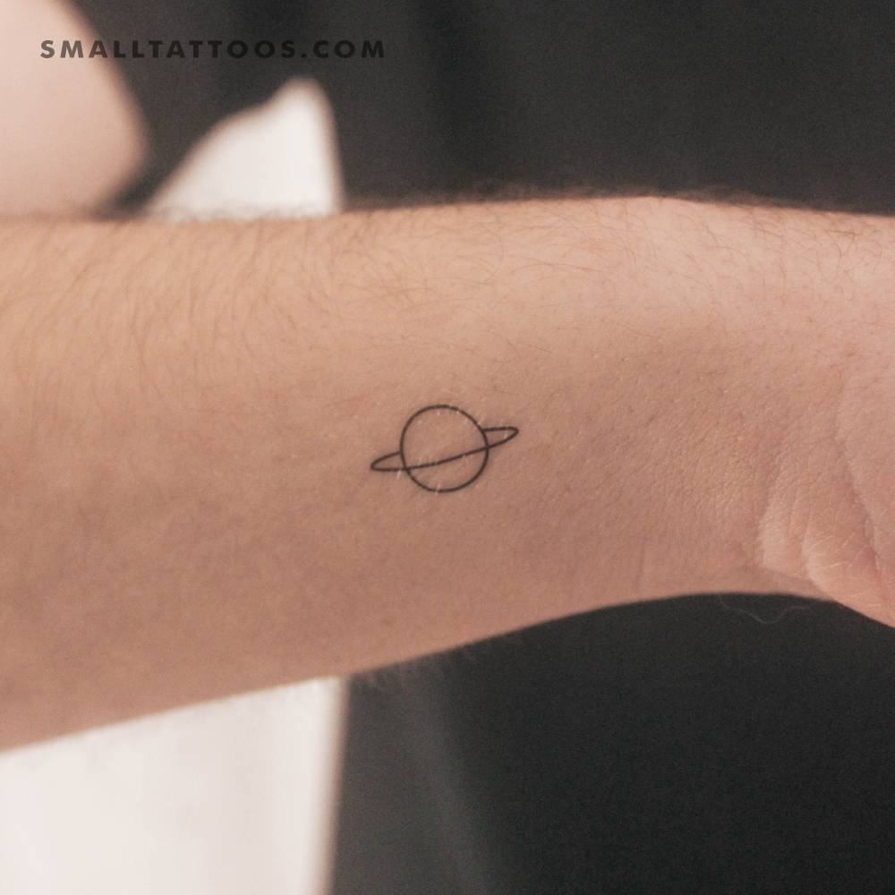 Minimalist Saturn temporary tattoo placed on the wrist.