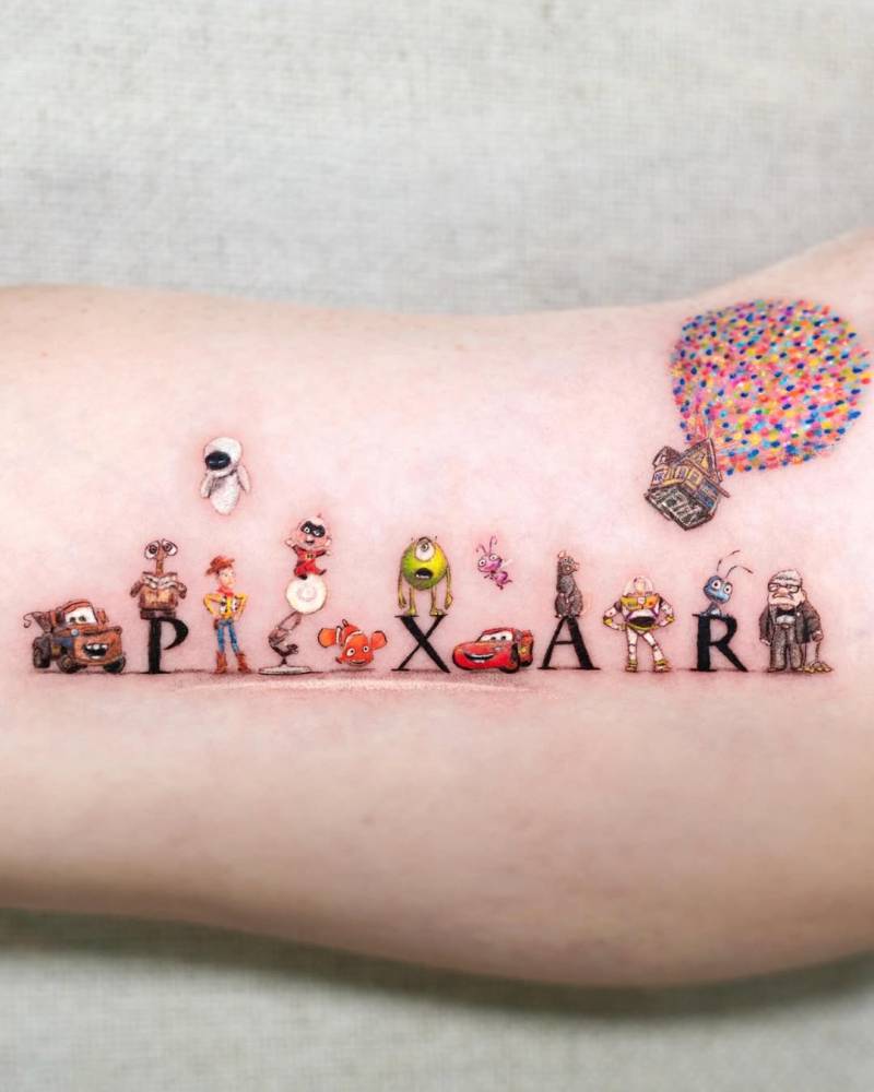 Cartoon style Pixar characters tattoo located on the inner arm.
