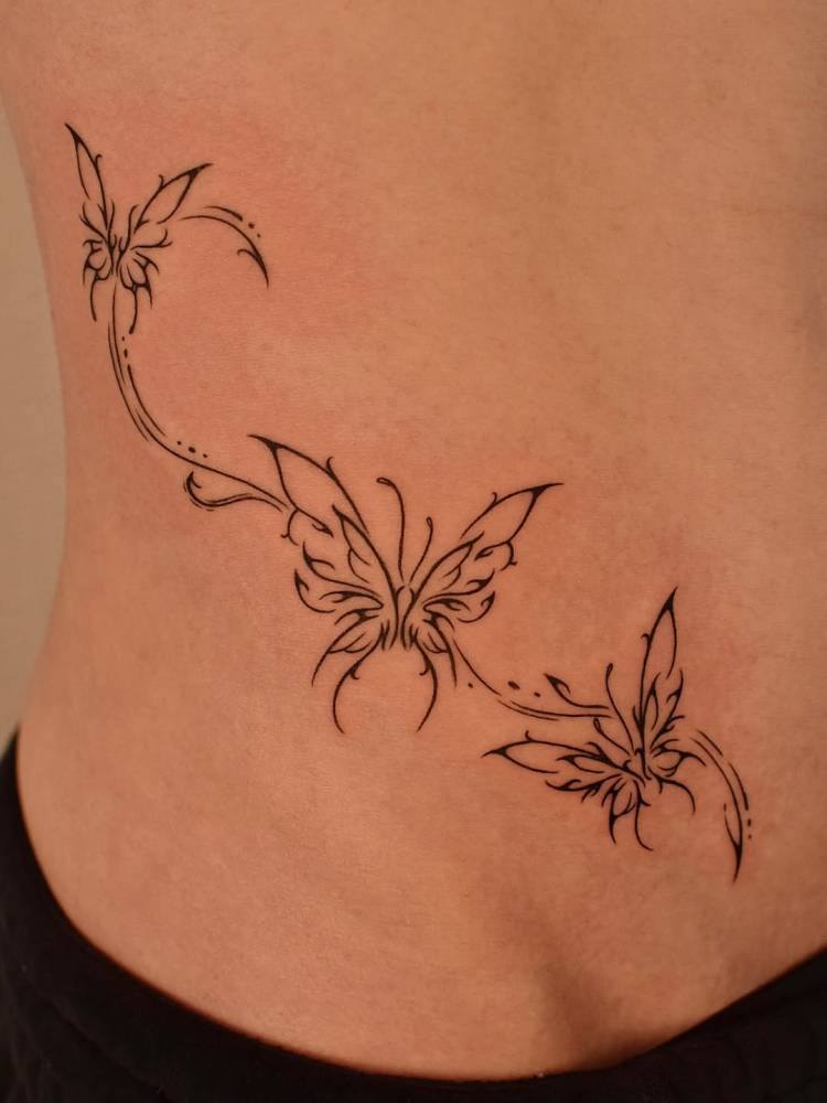 Tribal butterflies tattoo located on the waist.