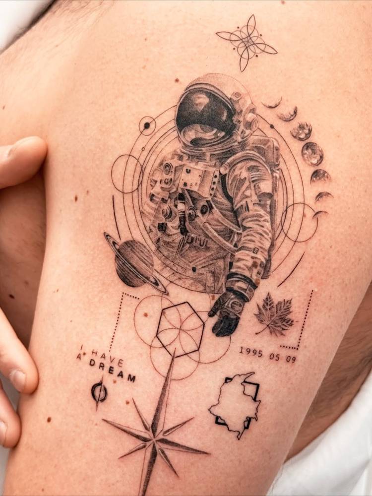 Graphic style astronaut tattoo located on the upper arm.