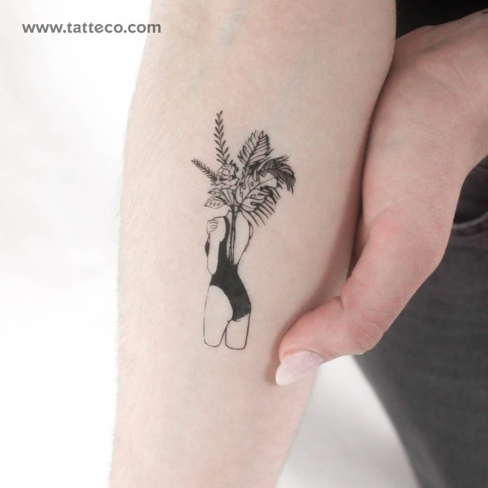 Flower head woman temporary tattoo located on the inner forearm.