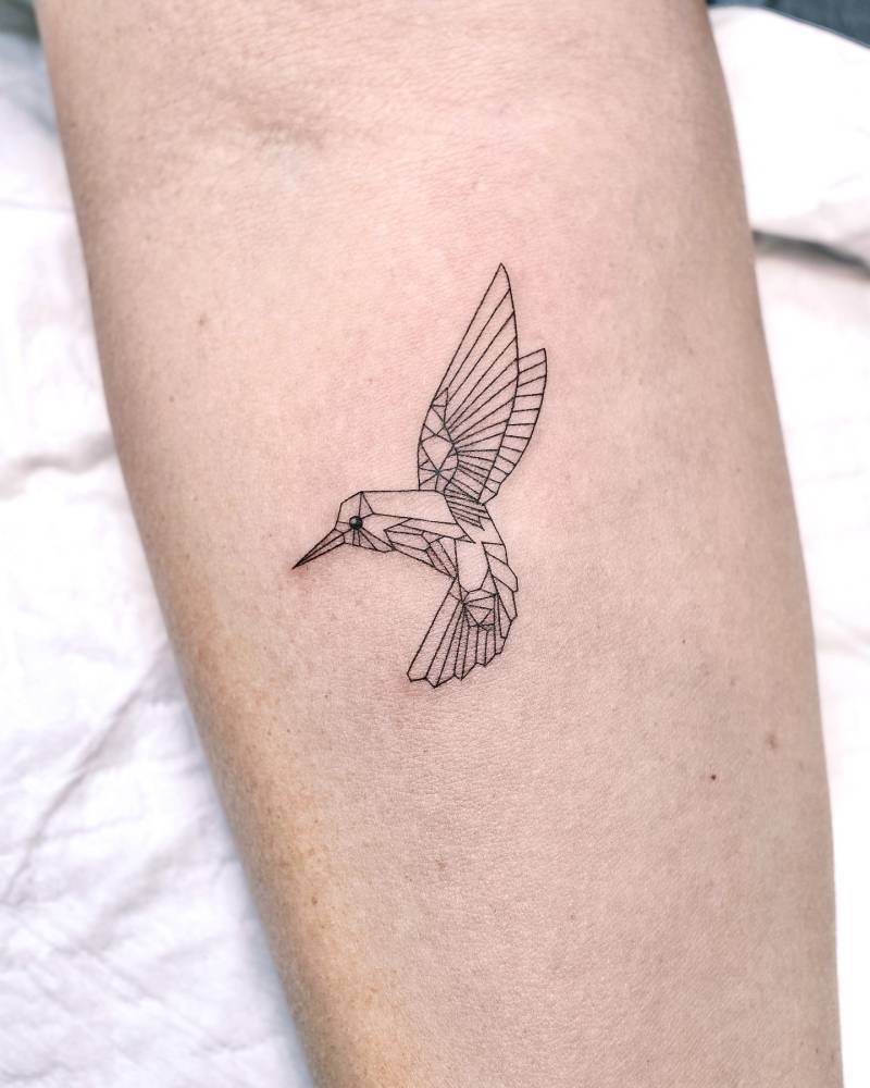 Low poly hummingbird tattoo located on the inner forearm.