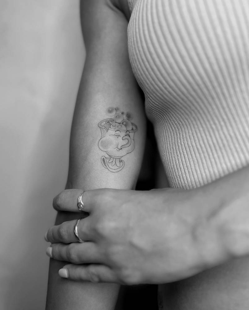 Cartoon style Chip tattoo placed on the inner arm.