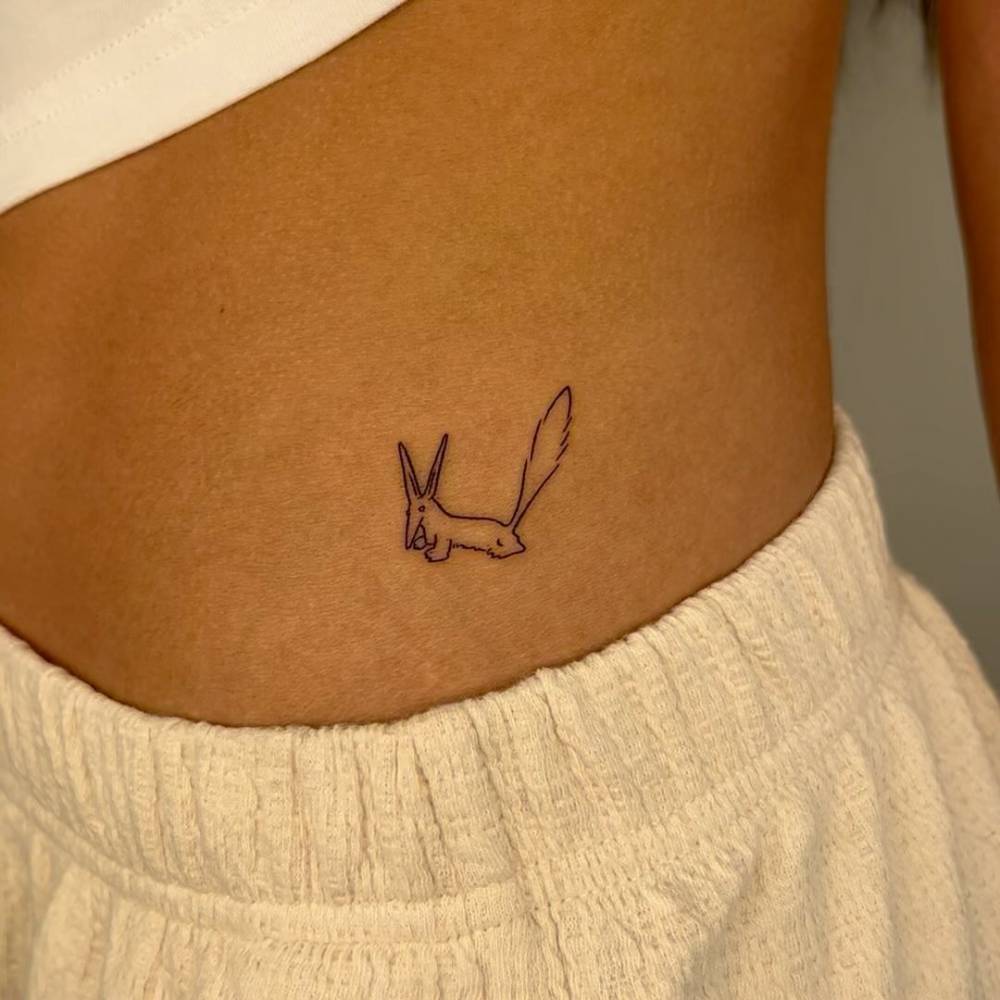 Minimalistic fox from 'The Little Prince' tattooed on the waist.