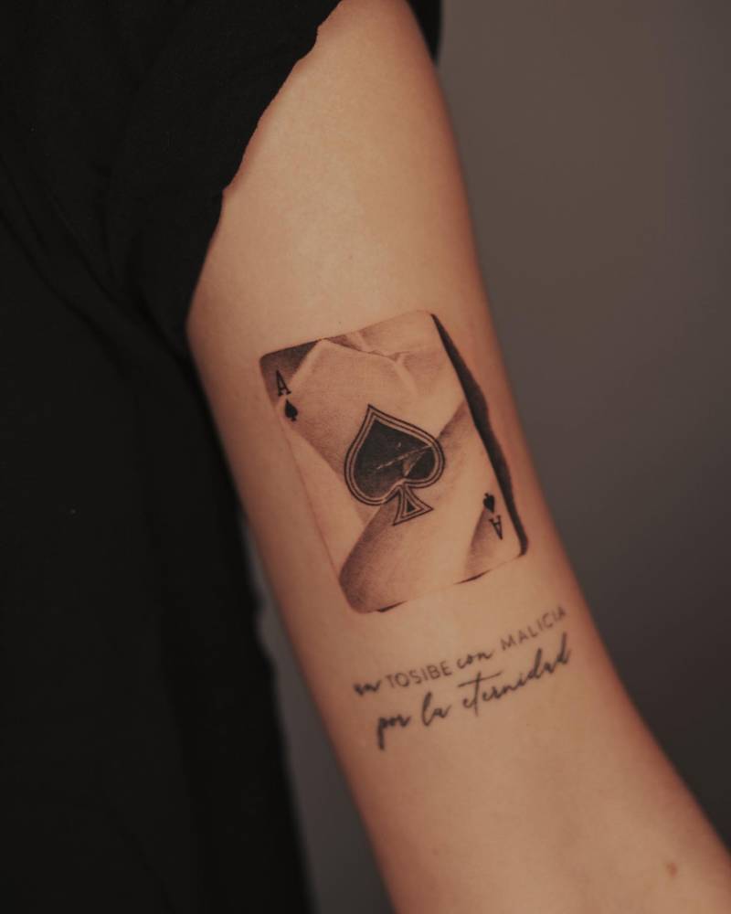 Micro-realistic style Ace of Spades tattoo located on the biceo.