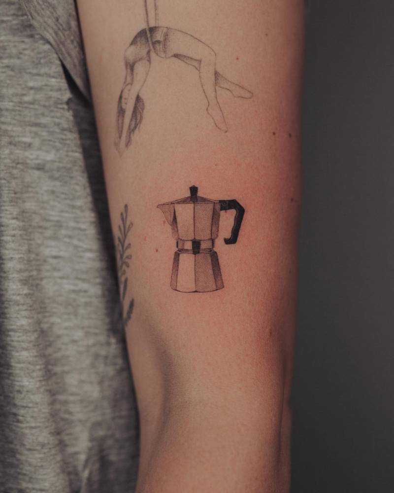 Micro-realistic style moka pot tattoo placed on the upper arm.