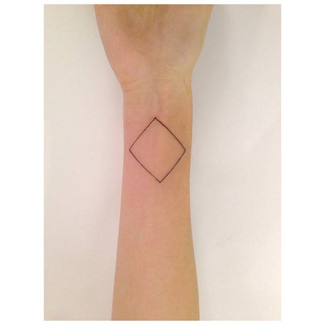 Rhombus tattoo in minimalistic style placed on the wrist.