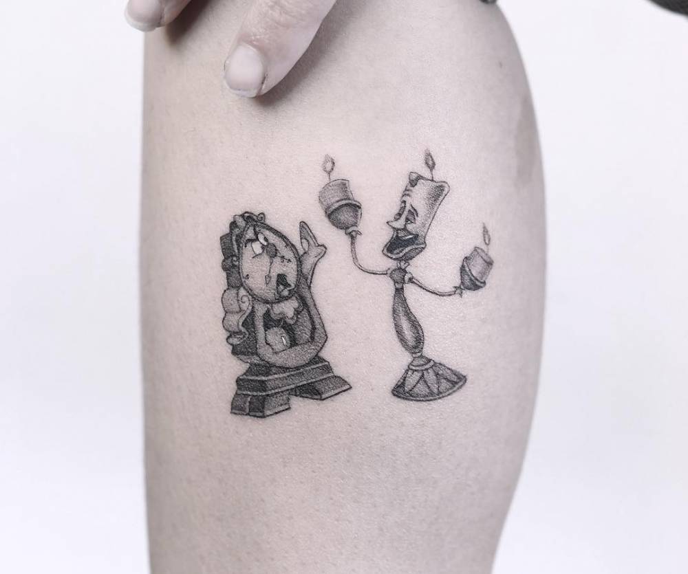 Cogsworth and Lumiere from 'Beauty and the Beast' tattooed on the calf.