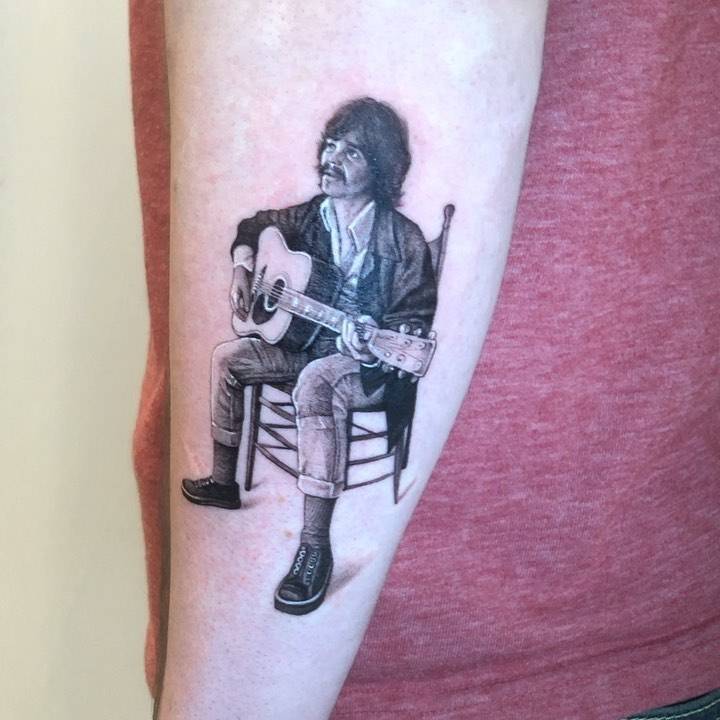 John Prine tattoo in micro-realistic style located on the forearm.