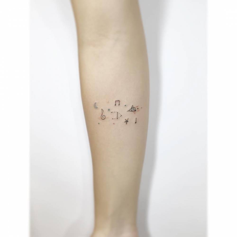 Little galaxy tattoo in minimalistic style located on the inner forearm.