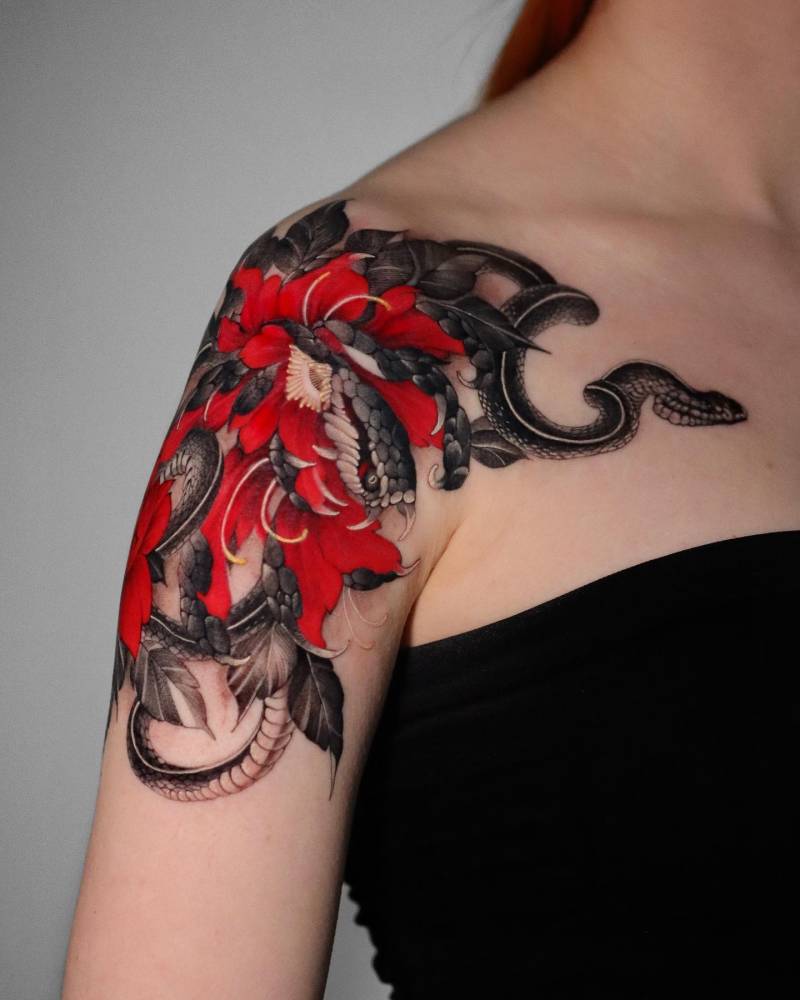 Chrysanthemum and snake tattoo located on the shoulder, oriental style.