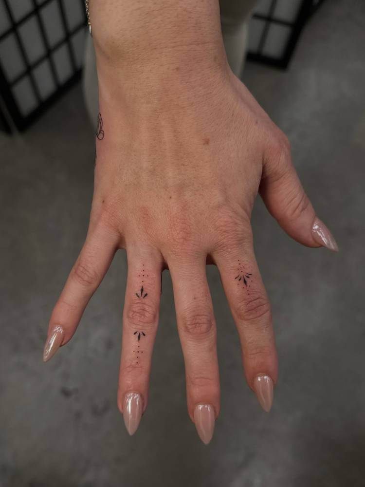 Minimalistic style finger ornaments tattoo.