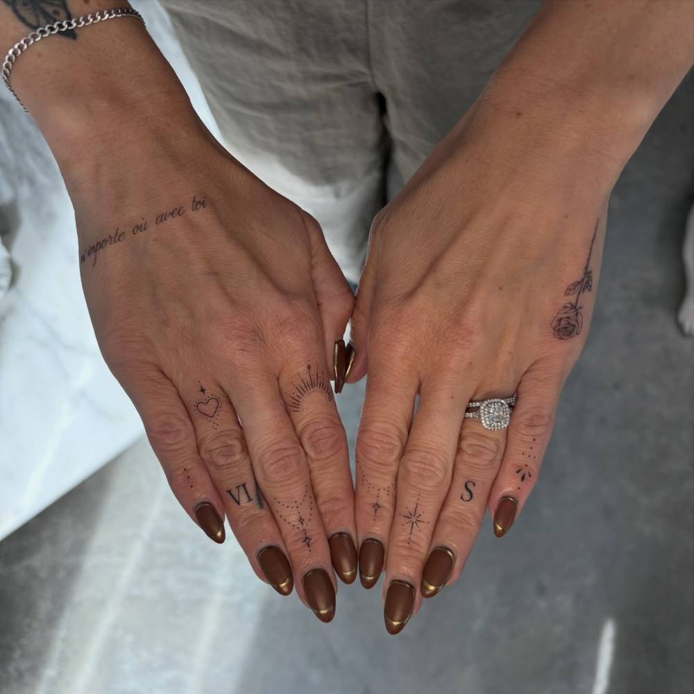 Fine line style finger composition tattoos.