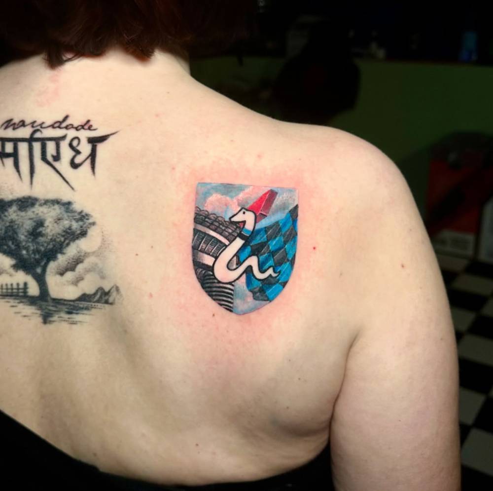 Vintage Inter Milan badge tattoo located on the shoulder blade.