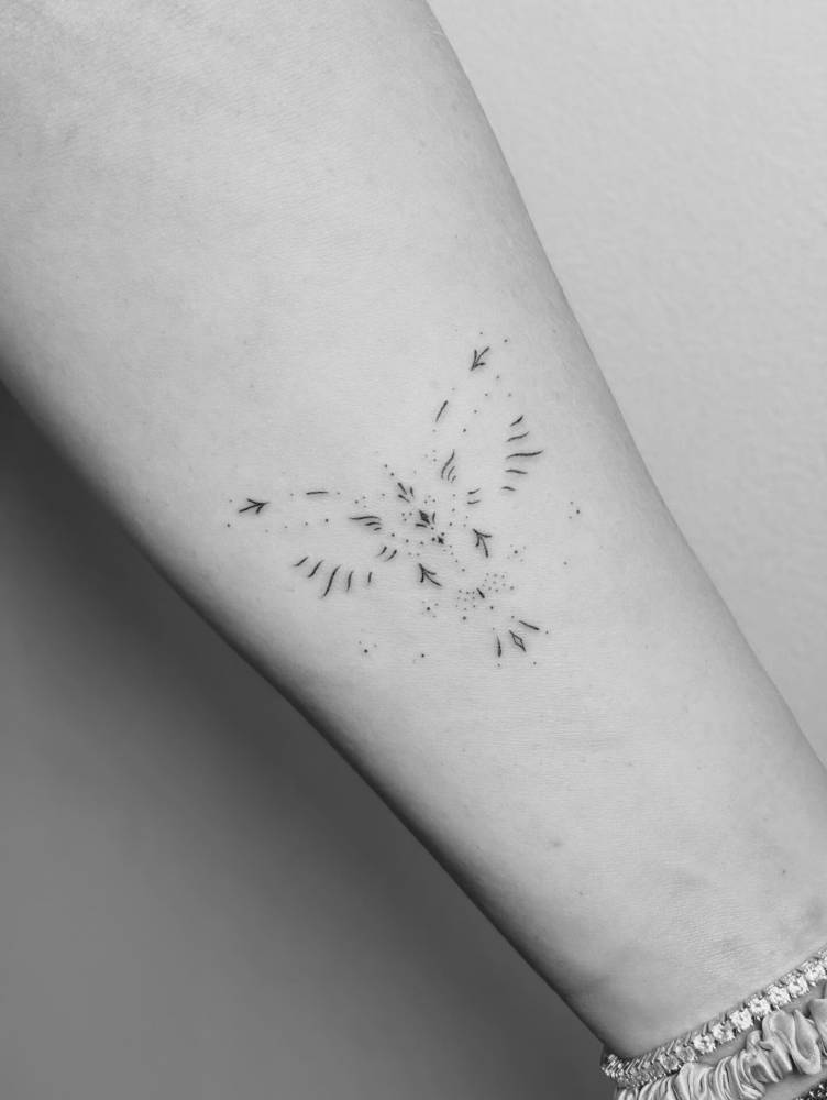 Ornamental bird tattoo located on the inner forearm.