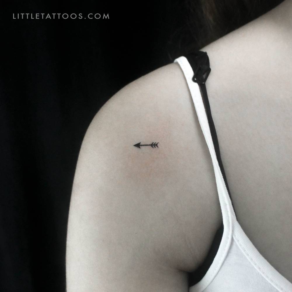 Tiny arrow temporary tattoo located on the shoulder.