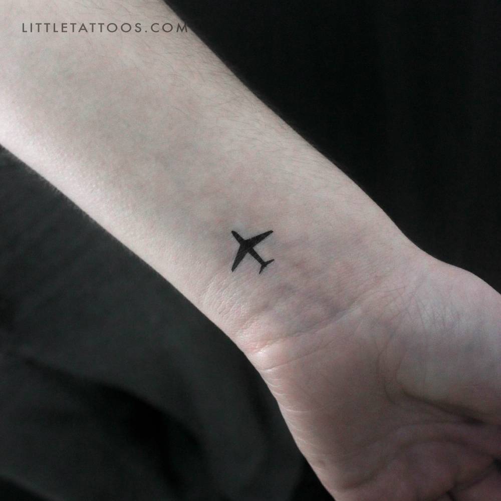 Small airplane temporary tattoo located on the wrist.