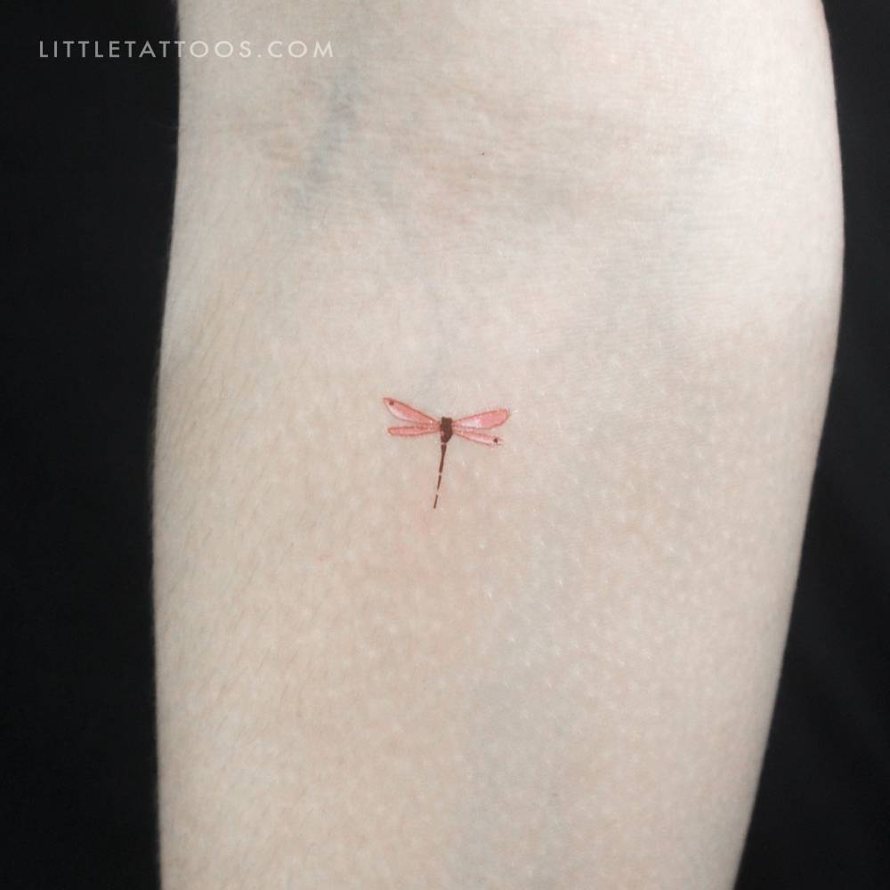 Red watercolor style dragonfly temporary tattoo located on the inner forearm.
