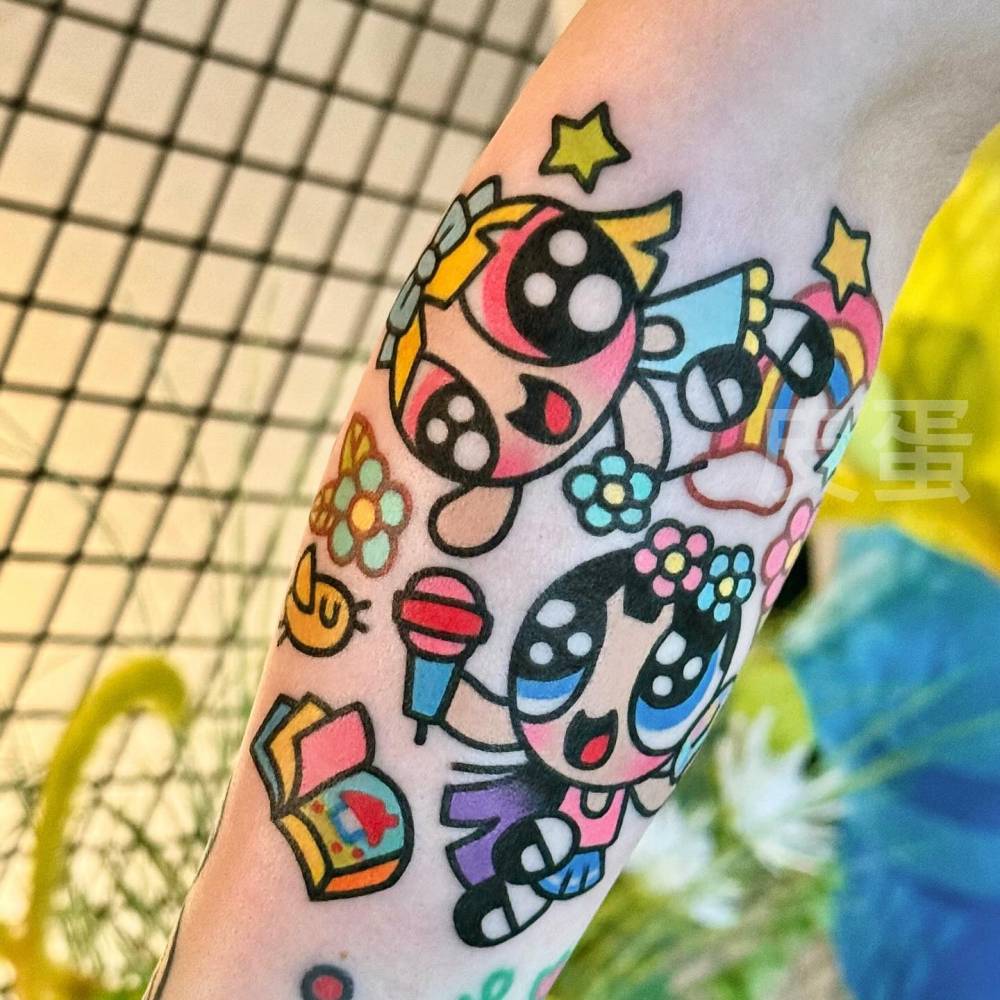 Blossom and Bubbles tattoo located on the forearm, cartoon style.