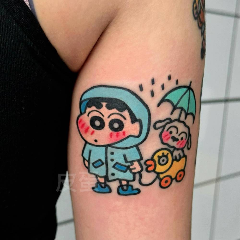Shin Chan tattoo in Kawaii style located on the tricep.