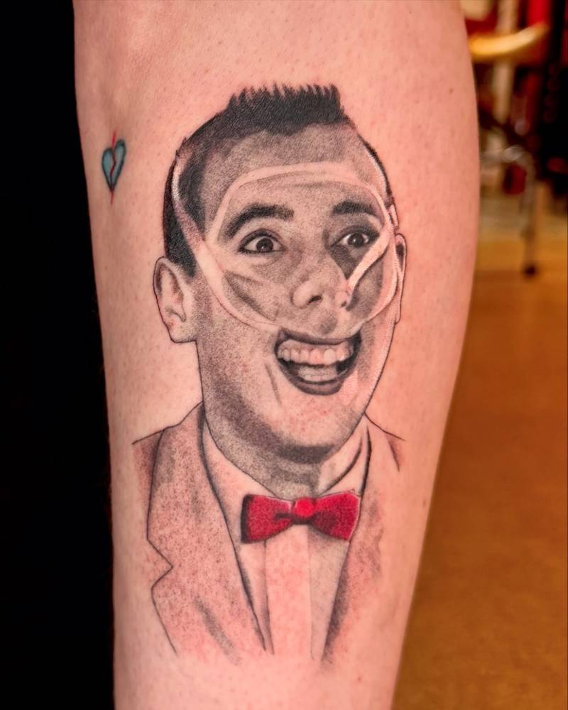 Pee-wee Herman portrait tattoo located on the shin.