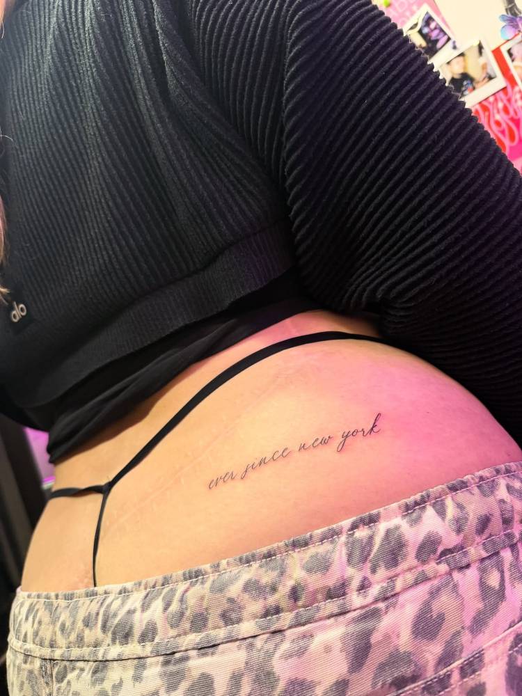 "Ever since New York" lettering tattoo located on the butt cheek.