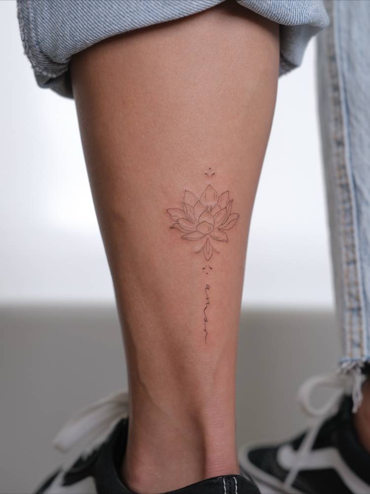 Lotus flower and word "amor" tattooed on the achilles.