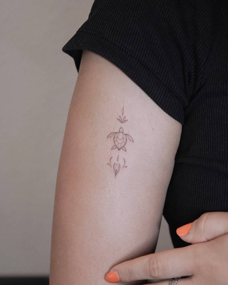 Ornamental turtle tattoo located on the upper arm.
