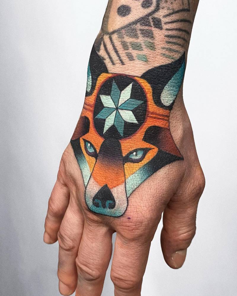Illustrative style fox portrait tattoo located on the hand.