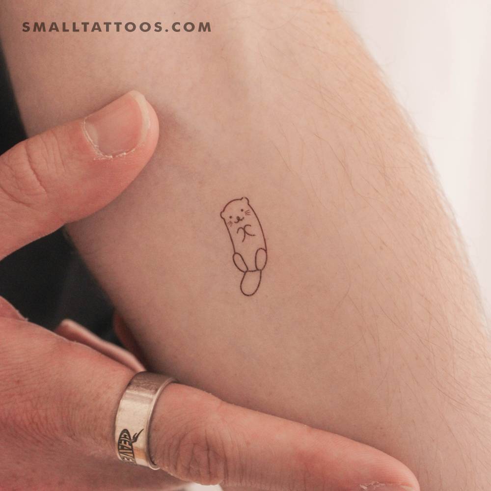 Tiny minimalistic otter temporary tattoo located on the inner forearm.