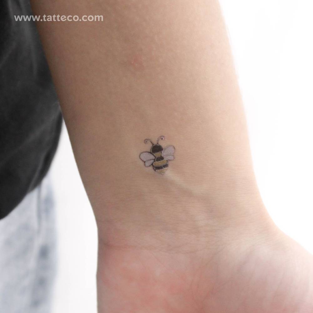 Silver bee temporary tattoo located on the wrist.