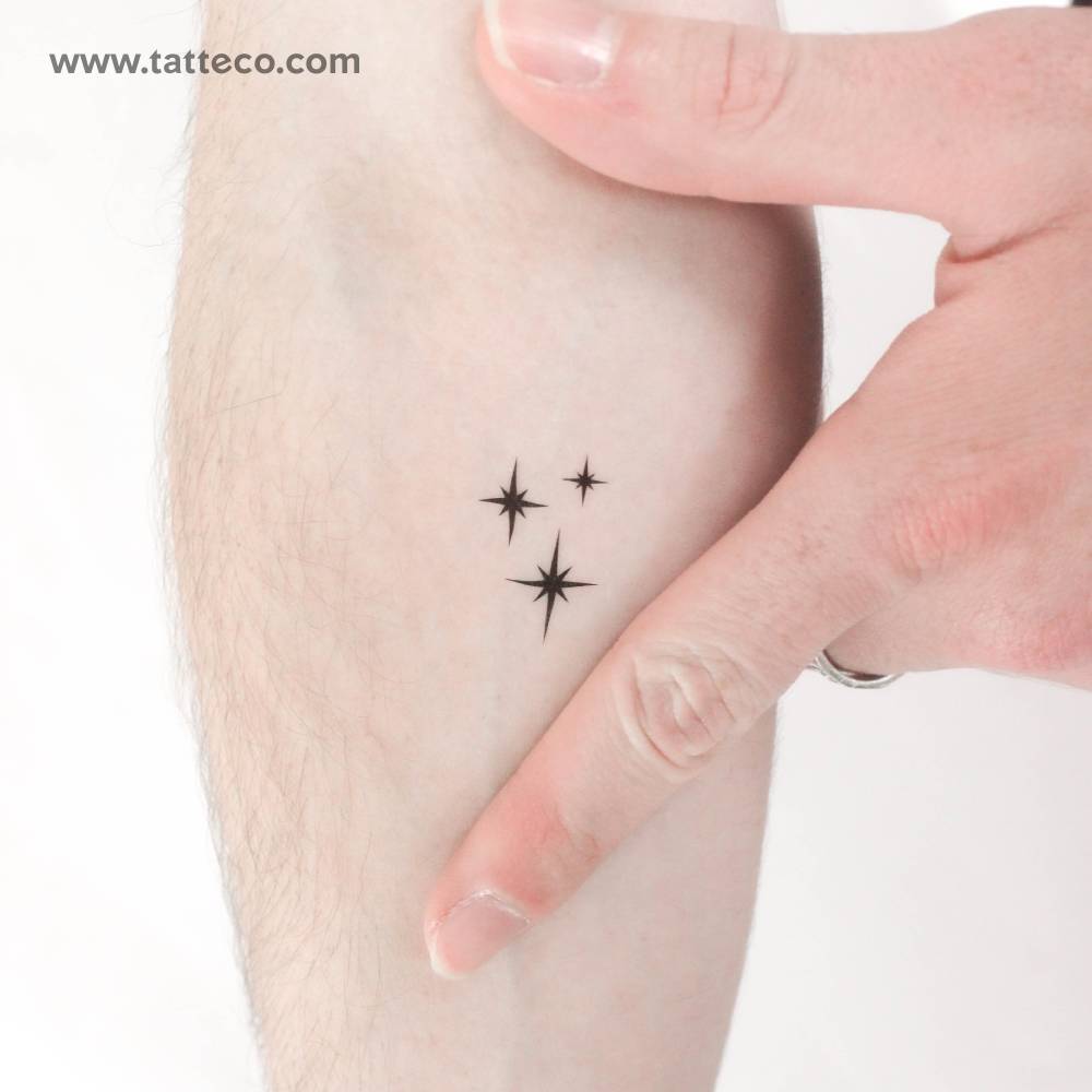 Small stardust/sparkle temporary tattoo located on the inner forearm.