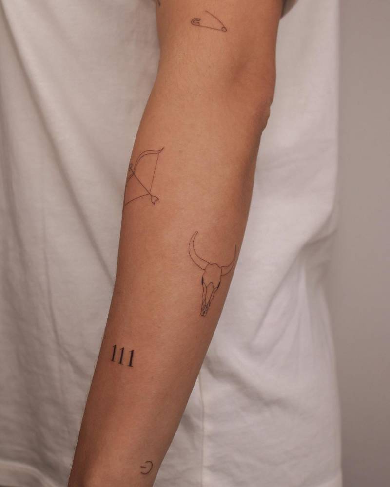 Little fine line arm tats.