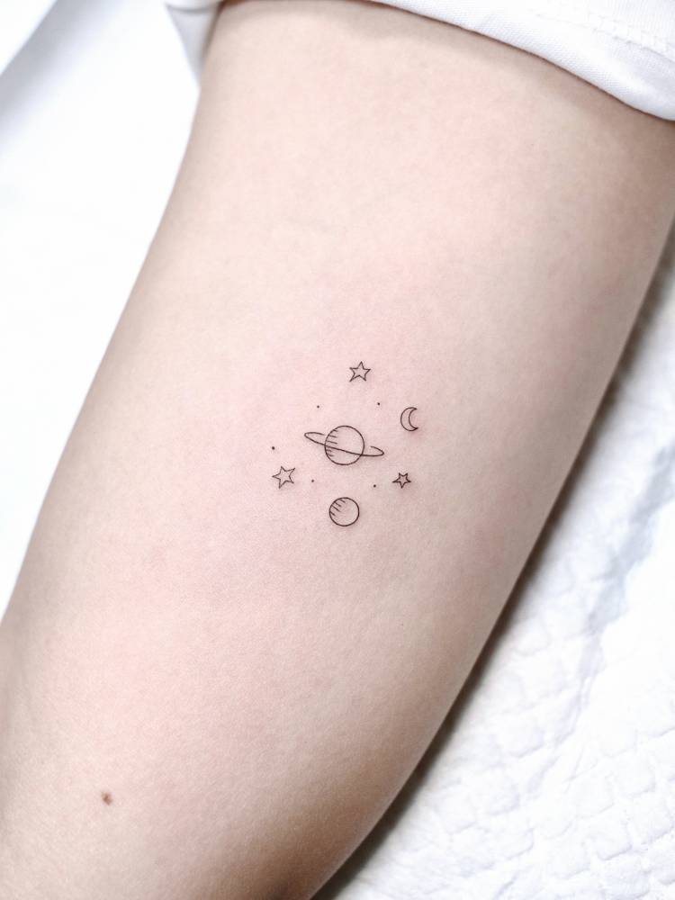 Little minimalistic universe tattoo located on the inner arm.
