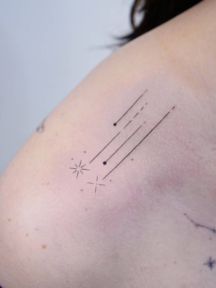 Shooting stars tattoo located on the top of shoulder,