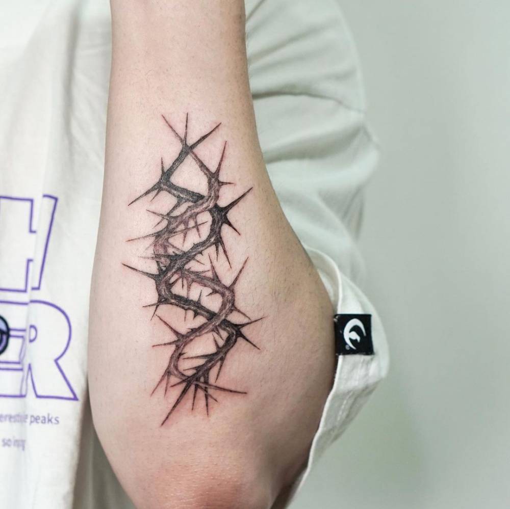 Thorns tattoo located on the forearm.