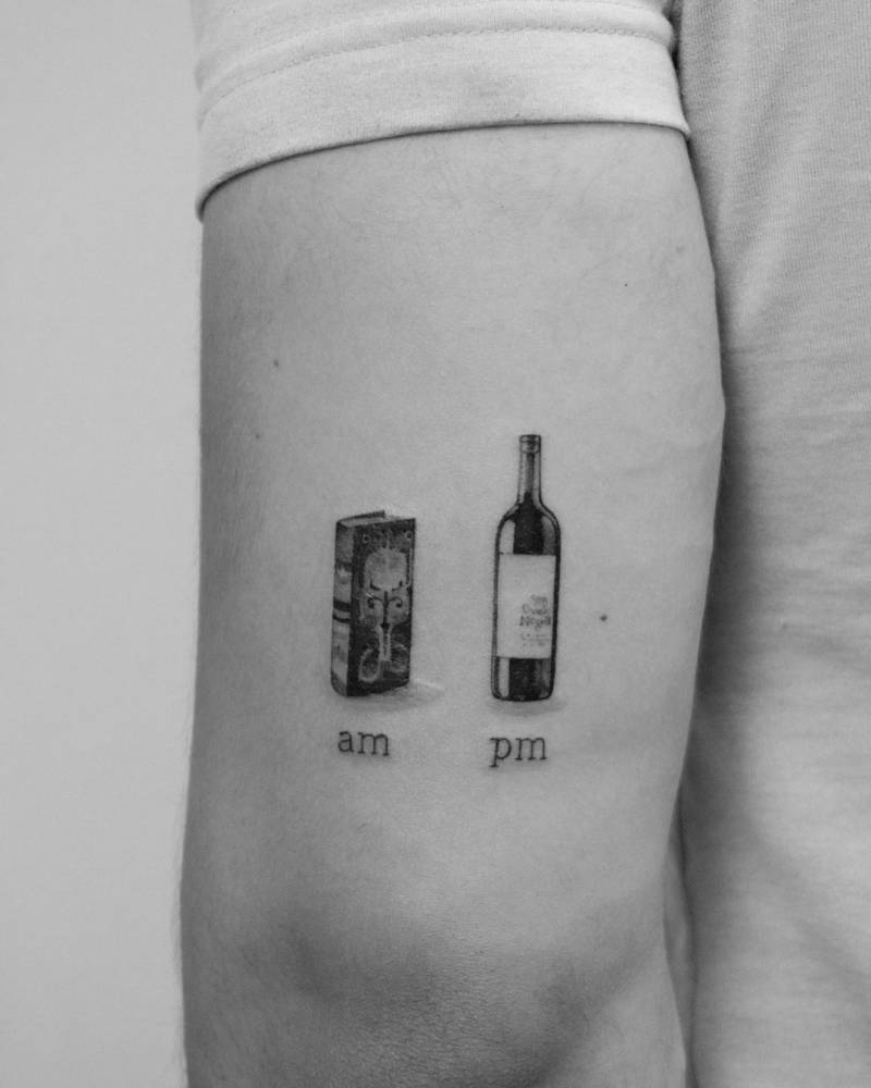 A.M. book, P.M. wine tattoo located on the tricep.