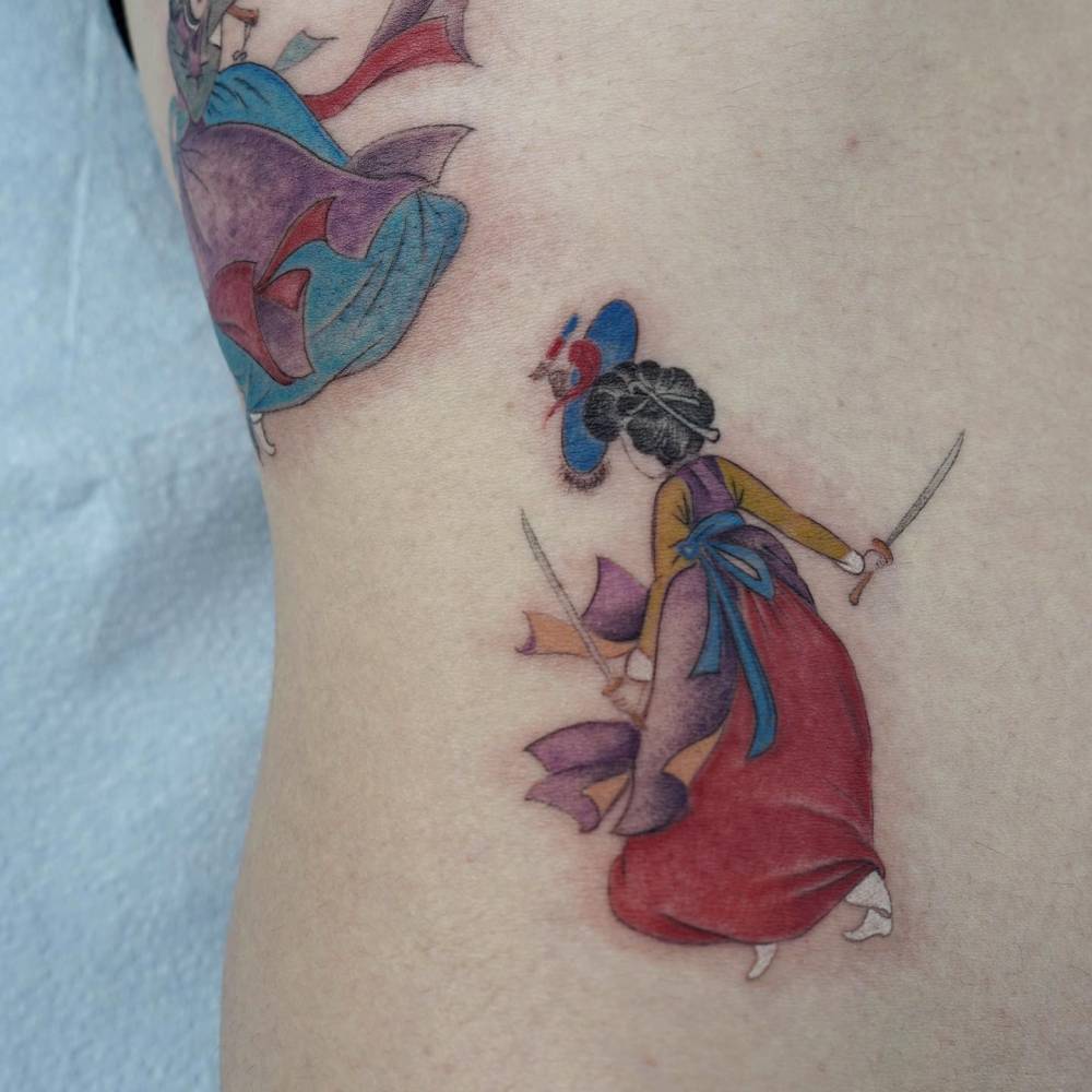 Sword dance tattoo located on the waist.
