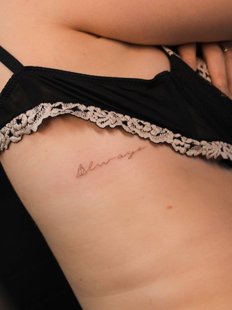 Word "always" and Deathly Hallows symbol tattooed on the rib.