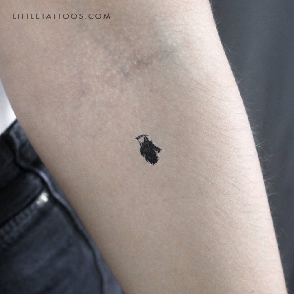 Small Grim Reaper temporary tattoo placed on the inner forearm.