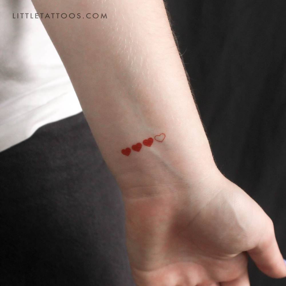 Red loading hearts temporary tattoo placed on the wrist.